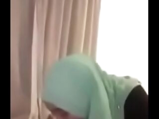 muslim hotel staff with hijab gives a buns and rails